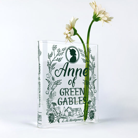 Anne of Green Gables acrylic book vase with white daisies on a white background