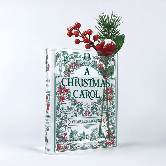 A Christmas Carol acrylic book vase with Christmas flowers and red berries