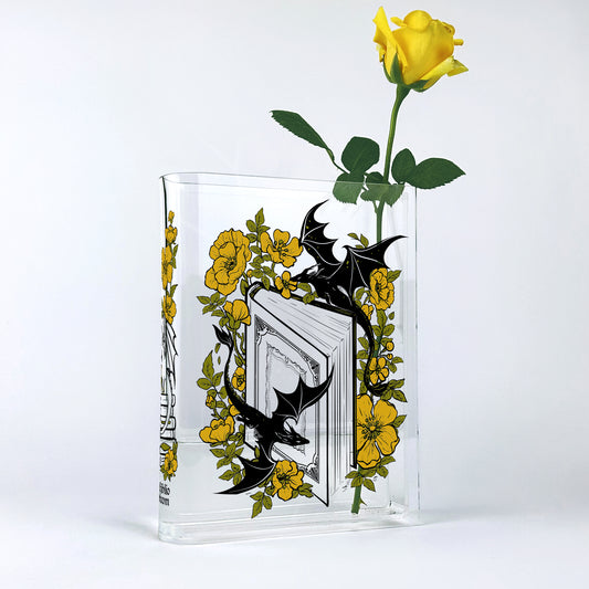 Acrylic book vase with yellow rose, dragon, and floral design on a white background