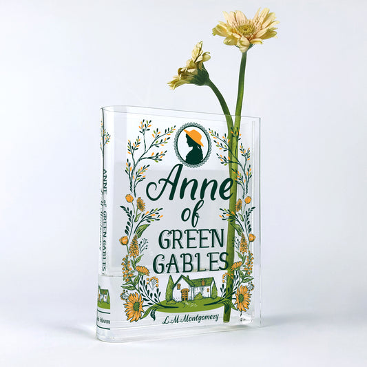 Anne of Green Gables acrylic book vase with yellow daisy flowers on white background